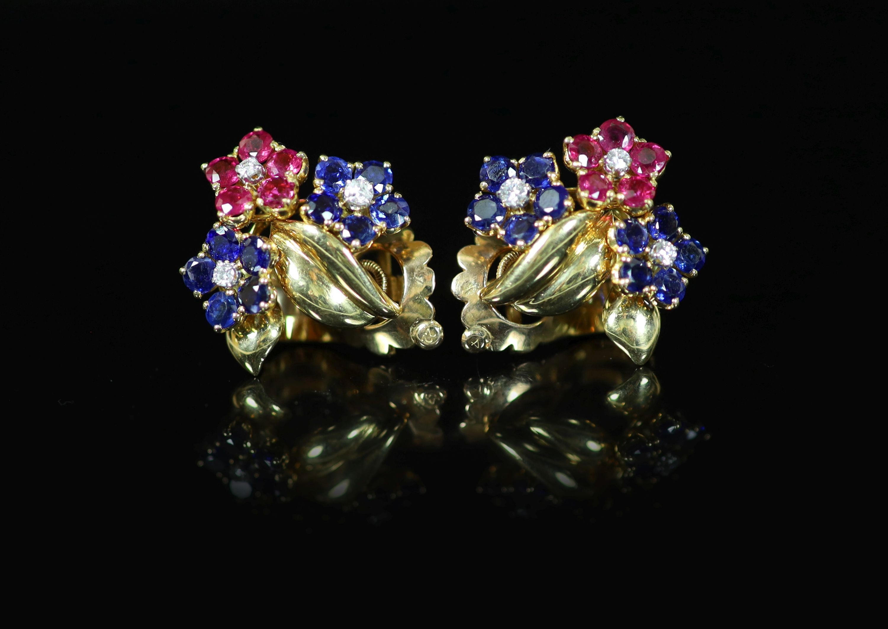 A pair of French Van Cleef & Arpels 18ct gold, ruby, diamond and sapphire set triple flower head cluster ear clips